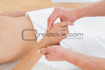 Close-up of a doctor examining a female patient's hand