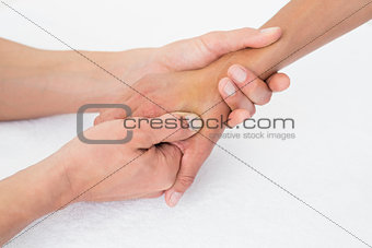 Doctor examining a female patient's hand
