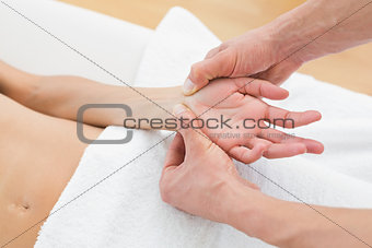 Doctor examining a female patient's wrist