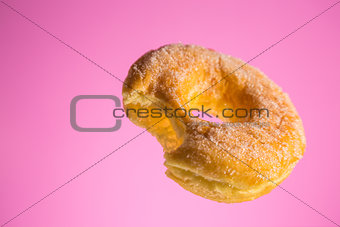 Sugar coated donut with bite mark