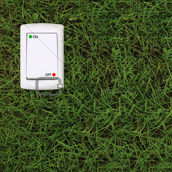 electric power switch on a green grass background