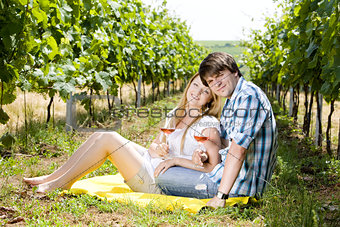 couple at a picnic in vineyard