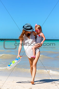 Mom daughter having a walk at the beach 