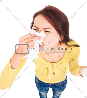 Young woman having  allergy and  blowing into tissue