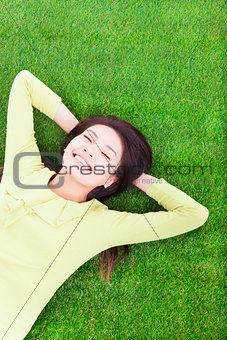 smiling woman lying on the grassland