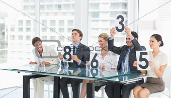 Judges in a row holding score signs