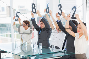 Judges in a row holding score signs