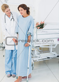 Doctor talking to patient in crutches