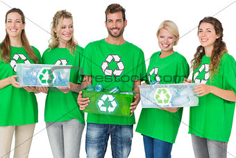 People in recycling symbol tshirts carrying boxes