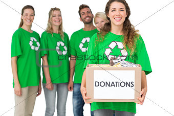 People in recycling symbol tshirts with donation box