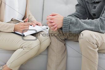 Mid section of a financial adviser and man