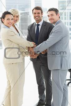 Portrait of business team joining hands together