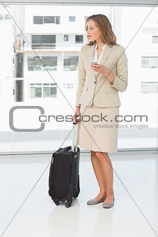 Businesswoman text messaging while on business trip