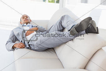 Businessman napping on the couch