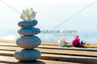 beautiful stones and flowers on a wooden pier 