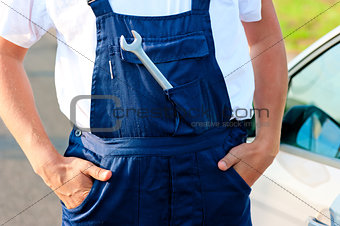 wrench sticking out of the pocket mechanic overalls