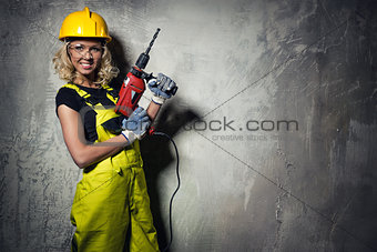 Builder woman with a drill