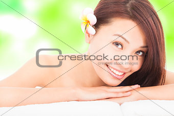 woman in spa club lying on the massage desk with towel