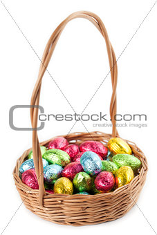 Chocolate eggs in a basket on white