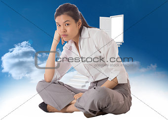 Composite image of businesswoman sitting cross legged