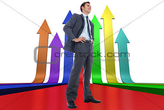 Composite image of happy businessman with hands on hips