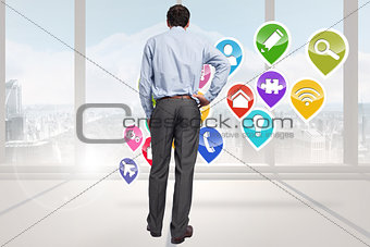 Composite image of businessman with hand on hip