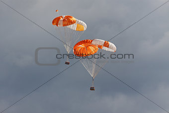 Freights on parachutes go down the earth