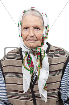 Portrait of a senior woman in headscarf looking at the camera. Over white background.