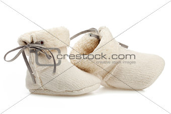 Pair of baby booties over white