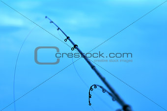 fishing rods on the background of blue water