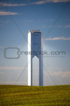 Solar Tower with rays  - thermo-solar power - blue sky and green