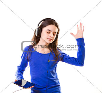 Smiling girl listening to music on digital tablet