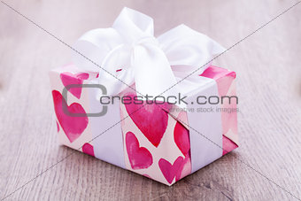 Pretty Valentines gift with hearts on the giftwrap