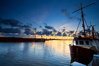 fishing boats on river at sunset