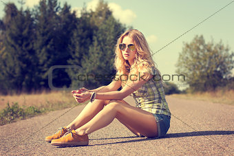 Trendy Hipster Girl Sitting on the Road