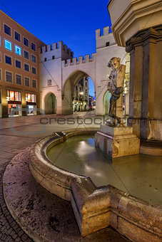 Brunnenbuberl Fountain and Karlstor Gate in the Evening, Munich,