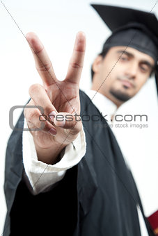 Indian male graduated holding victory sign