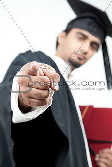 young boy graduated pointing finger in the camera to motivate
