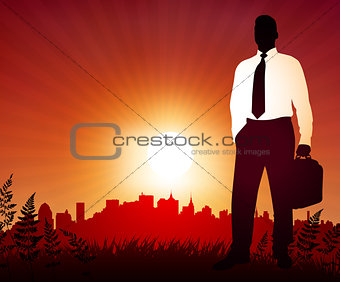 Businessman on sunset background with skyline