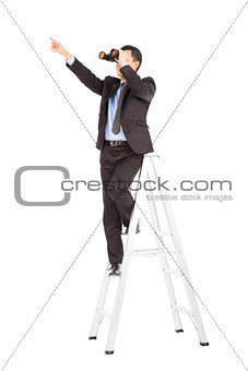 asian businessman using binoculars standing  on stair