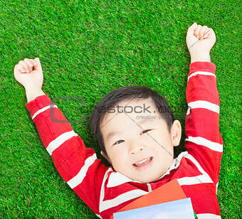 Beauty smiling child boy resting and hand up with books