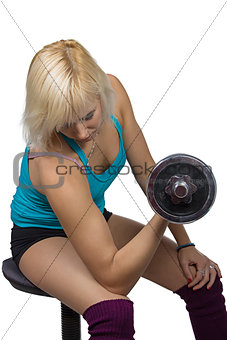 Athletic girl making exercises with dumbbell