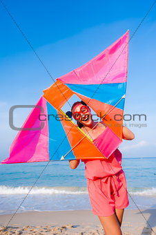 Girl in dress with sunglasses on the sea beach with kite have jo