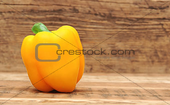 yellow paprika on wooden table