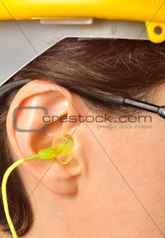 yellow earplug into the ear