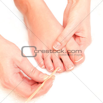 woman pushing cuticles toes