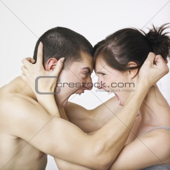 Couple locked in angry embrace
