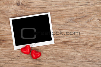 Blank instant photo and red candy hearts