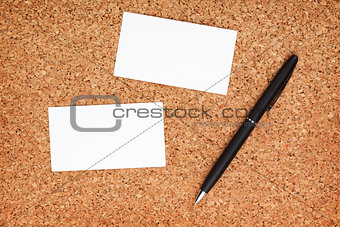Two business cards and pen