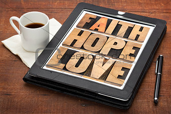 faith, hope and love on digital tablet